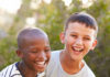 A black boy laughing with a white boy