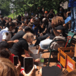 Faith and Soboma Wokoma, who helped host the event, sat down on a park bench and members of the community surrounded them, washing their feet while asking for forgiveness. Source: Tori Bush