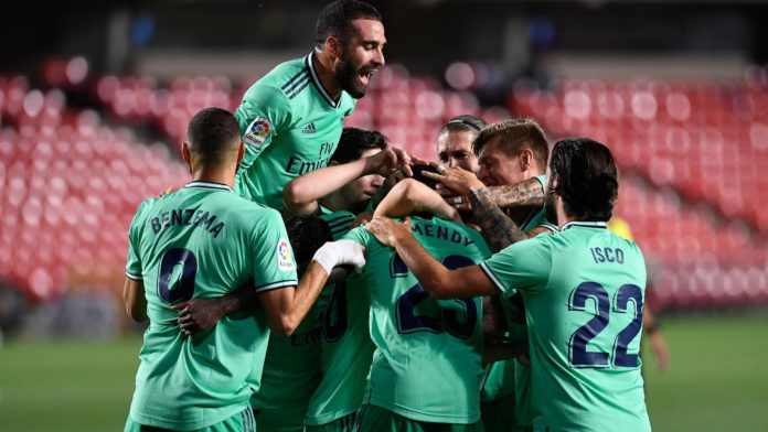 Real Madrid's players celebrate after French defender Ferland Mendy scored during the Spanish league football match Granada FC vs Real Madrid CF at Nuevo Los Carmenes stadium in Granada on July 13, 2020. Image credit: Getty Images