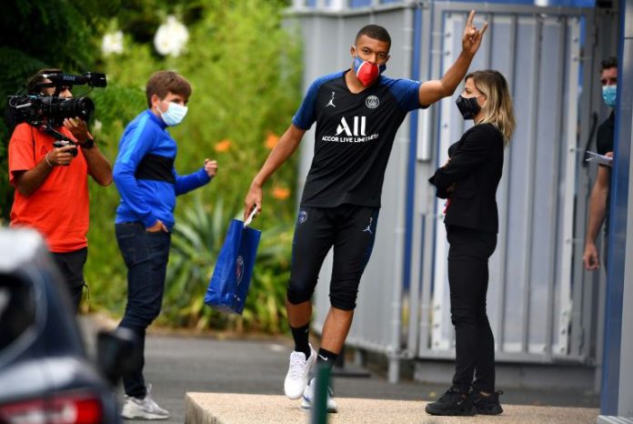 Paris Saint-Germain forward Kylian MBappe waved as he arrived for a training session and will get to play in front of fans at Le Havre on Sunday (AFP Photo/FRANCK FIFE)