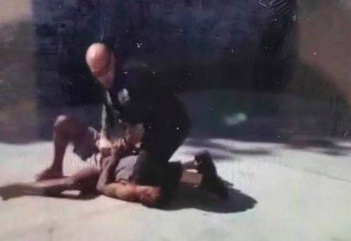 police kneel on man