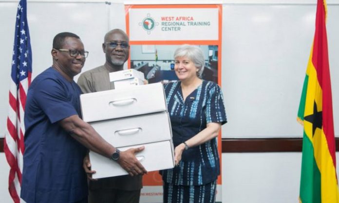 This screenshot from the U.S. Embassy in Ghana website shows Ambassador Stephanie Sullivan, right, donating technology to the executive director of the Economic and Organized Crime Office, Frank Adu-Poku, rear, and Jacob Puplampu, left, at a “cyber dark web investigations training” session in Accra in May 2019.