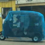 Man covers his tricycle with mosquito net to protect himself against Coronavirus