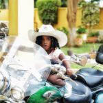 Gifty Anti's daughter, Nyame Anuonyam poses on father's motorbike