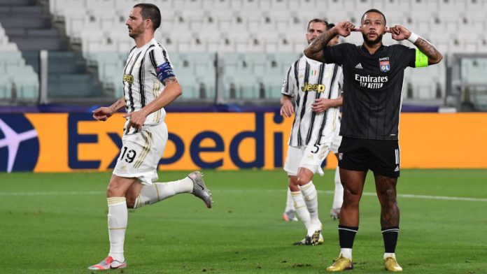 Lyon's Dutch forward Memphis Depay (R) celebrates scoring his team's first goal during the UEFA Champions League round of 16 second leg football match between Juventus and Olympique Lyonnais (OL), played behind closed doors due to the spread of the COVID- Image credit: Getty Images