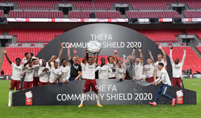 Arsenal's Gabonese striker Pierre-Emerick Aubameyang lifts the trophy after winning the English FA Community Shield football match between Arsenal and Liverpool at Wembley Stadium in north London on August 29, 2020. - Arsenal won the match 5-4 in a penalty shootout after drawing 1-1 in normal time. (Photo by JUSTIN TALLIS / POOL / AFP) / NOT FOR MARKETING OR ADVERTISING USE / RESTRICTED TO EDITORIAL USE