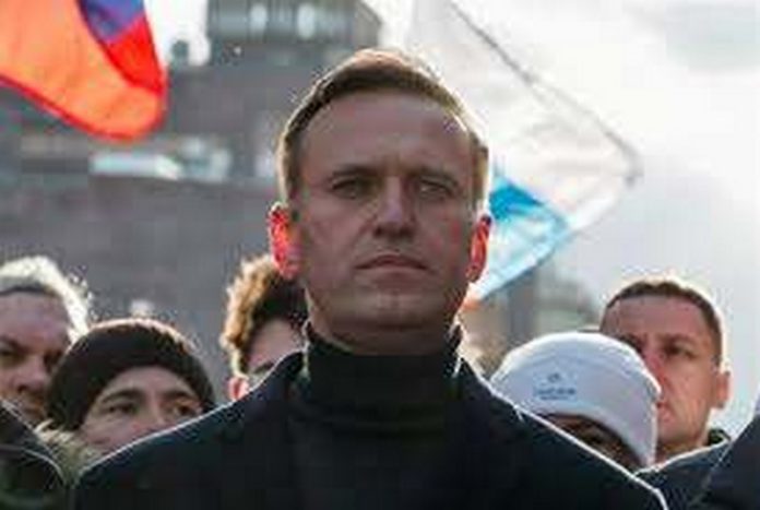 FILE - In this Feb. 29, 2020, file photo, Russian opposition activist Alexei Navalny takes part in a march in memory of opposition leader Boris Nemtsov in Moscow, Russia. Navalny has been poisoned and hospitalized on Thursday morning, Aug. 20, 2020 his spokeswoman Kira Yarmysh said on Twitter, Navalny felt unwell on a flight back to Moscow from Tomsk, a city in Siberia. (AP Photo/Pavel Golovkin, File)