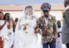 Kojo Antwi walking his fan Efia Antwiwaa Kajah to the altar