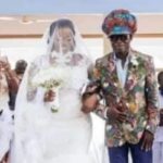 Kojo Antwi walking his fan Efia Antwiwaa Kajah to the altar