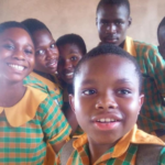 Gideon Nhyiraba and some of his classmates take a picture after writing BECE