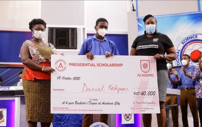 Dr. Lucy Agyepong (right) and Ms. Shannan Akosua Magee of Academic City presenting the scholarship to Mr. Daniel Kekeli Gakpetor (middle)