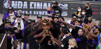 The Los Angeles Lakers players celebrate after the Lakers defeated the Miami Heat 106-93 in Game 6 of basketball's NBA Finals Sunday, Oct. 11, 2020, in Lake Buena Vista, Fla. (AP Photo/John Raoux)