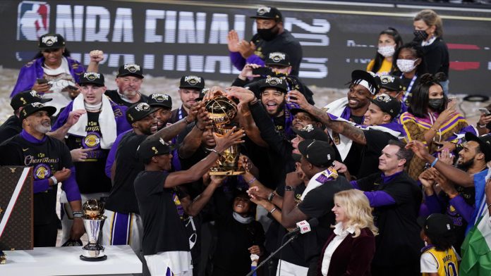 The Los Angeles Lakers players celebrate after the Lakers defeated the Miami Heat 106-93 in Game 6 of basketball's NBA Finals Sunday, Oct. 11, 2020, in Lake Buena Vista, Fla. (AP Photo/John Raoux)