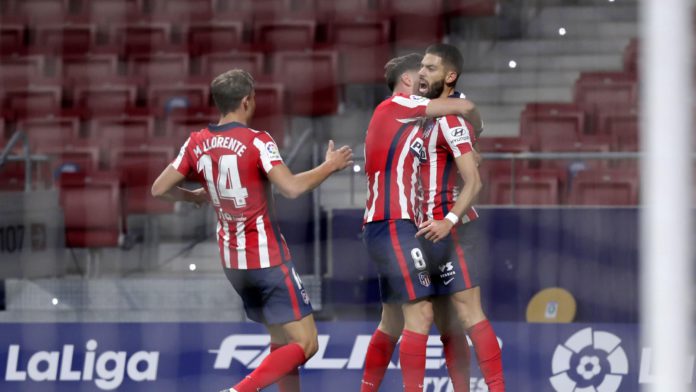 Yannick Carrasco of Atletico de Madrid celebrates with teammate Marcos Llorente and Saul Niguez after scoring his team's first goal during the La Liga Santander match between Atletico de Madrid and FC Barcelona at Estadio Wanda Metropolitano Image credit: Getty Images