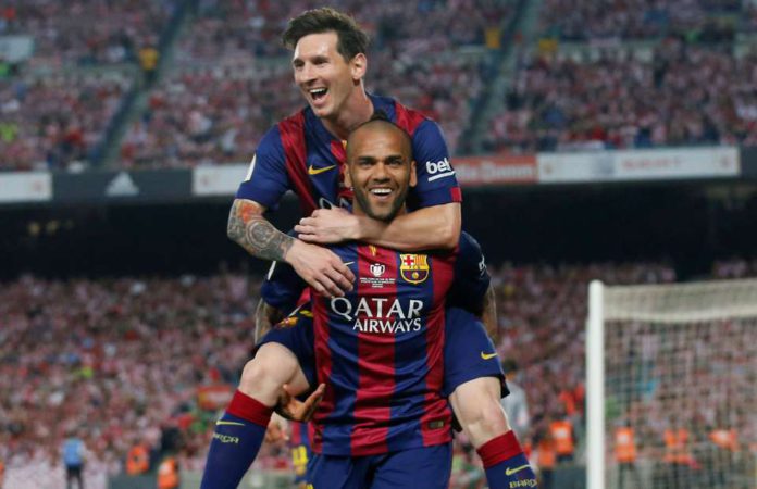 Dani Alves celebrates with Lionel Messi