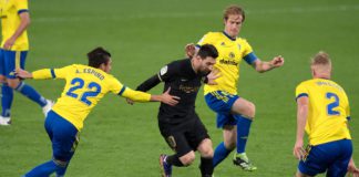 Cadiz players surround Lionel Messi Image credit: Getty Images