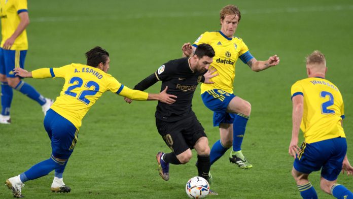 Cadiz players surround Lionel Messi Image credit: Getty Images