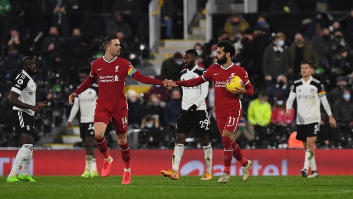 Liverpool's Egyptian midfielder Mohamed Salah (2nd R) celebrates with Liverpool's English midfielder Jordan Henderson after scoring their first goal from the penalty spot during the English Premier League football match between Fulham and Liverpool at Cra Image credit: Getty Images