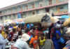 Shoppers on the street in front of the Makola Market in Accra.