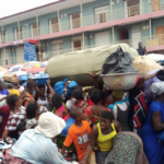 Shoppers on the street in front of the Makola Market in Accra.