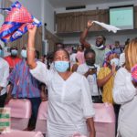 Lydia Alhassan waves an NPP flag to signify victory after she floored John Dumelo at Ayawaso West Wuogon