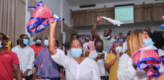 Lydia Alhassan waves an NPP flag to signify victory after she floored John Dumelo at Ayawaso West Wuogon