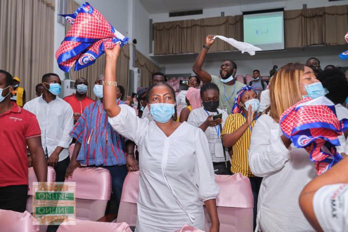 Lydia Alhassan waves an NPP flag to signify victory after she floored John Dumelo at Ayawaso West Wuogon