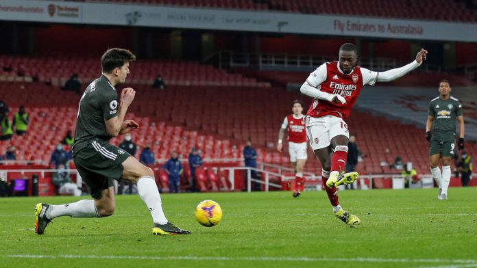 Manchester United's English defender Harry Maguire (L) blocks a shot from Arsenal's French-born Ivorian midfielder Nicolas Pepe during the English Premier League football match between Arsenal and Manchester United at the Emirates Stadium in London on Jan Image credit: Getty Images