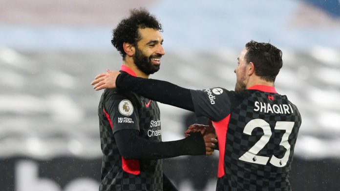 Mohamed Salah of Liverpool celebrates scoring his side's second goal with team mate Xherdan Shaqiri during the Premier League match between West Ham United and Liverpool at London Stadium Image credit: Getty Images