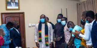 Dr. Matthew Opoku-Prempeh being decorated with a sash