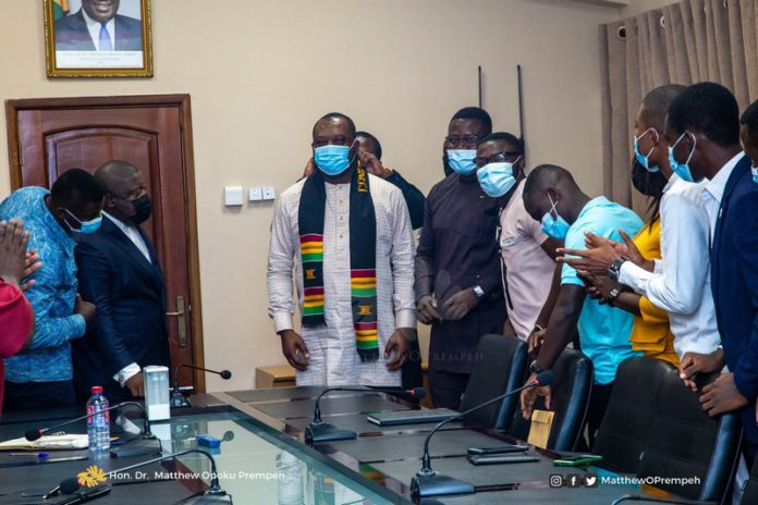 Dr. Matthew Opoku-Prempeh being decorated with a sash