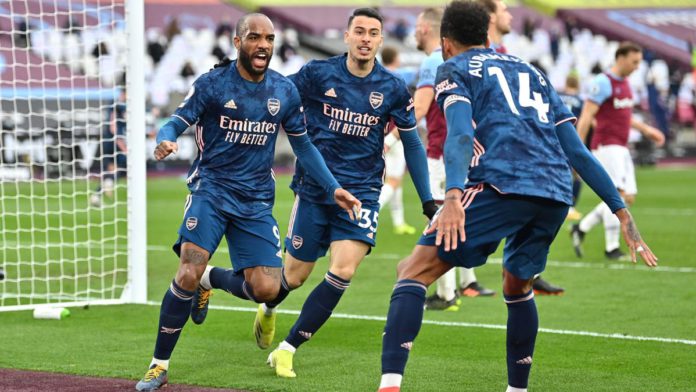 Alexandre Lacazette of Arsenal celebrates with Gabriel Martinelli and Pierre Emerick Aubameyang after scoring their side's third goal during the Premier League match between West Ham United and Arsenal Image credit: Getty Images