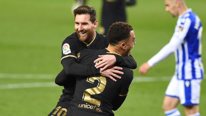 Barcelona's Barcelona's US defender Sergino Dest celebrates with Barcelona's Argentinian forward Lionel Messi (back) after scoring a goal during the Spanish League football match between Real Sociedad and Barcelona Image credit: Getty Images