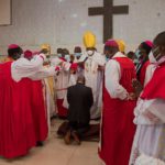 pastors surround Akufo-Addo as he kneels down for prayers