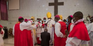 pastors surround Akufo-Addo as he kneels down for prayers