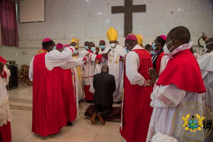 pastors surround Akufo-Addo as he kneels down for prayers