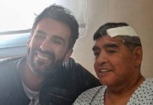 THIS HANDOUT PHOTO RELEASED BY THE PRESS OFFICER FOR DIEGO ARMANDO MARADONA SHOWS THE ARGENTINE FOOTBALL LEGEND SHAKING HANDS WITH HIS DOCTOR, LEOPOLDO LUQUE, AT THE OLIVOS CLINIC