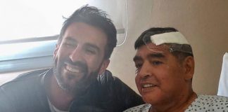 THIS HANDOUT PHOTO RELEASED BY THE PRESS OFFICER FOR DIEGO ARMANDO MARADONA SHOWS THE ARGENTINE FOOTBALL LEGEND SHAKING HANDS WITH HIS DOCTOR, LEOPOLDO LUQUE, AT THE OLIVOS CLINIC