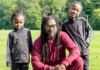 Samini and his two kids show off their Rastafarian dreadlocks