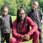 Samini and his two kids show off their Rastafarian dreadlocks