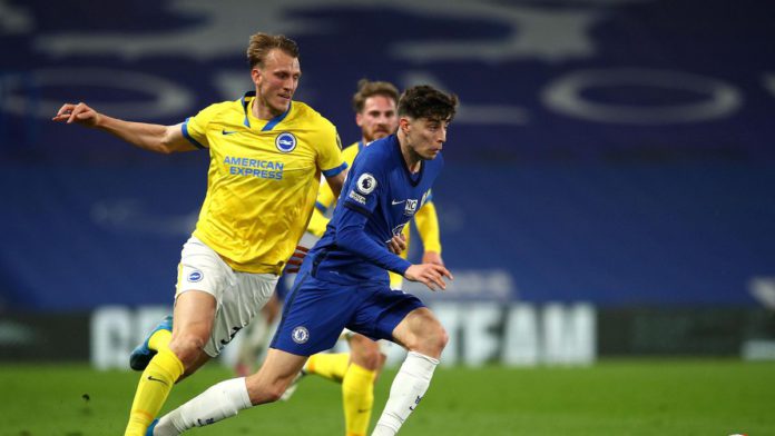Kai Havertz of Chelsea runs with the ball under pressure from Dan Burn of Brighton and Hove Albion during the Premier League match between Chelsea and Brighton & Hove Albion at Stamford Bridge on April 20, 2021 in London, England Image credit: Getty Images