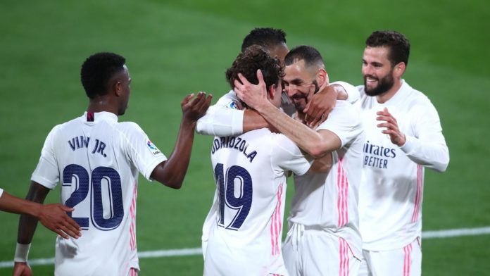 Alvaro Odriozola of Real Madrid celebrates with Karim Benzema after scoring their side's second goal during the La Liga Santander match between Cadiz CF and Real Madrid at Estadio Ramon de Carranza on April 21, 2021 in Cadiz, Spain Image credit: Getty Images