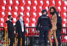 A streaker is being apprehended by the police © Getty Images