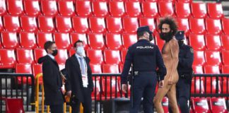 A streaker is being apprehended by the police © Getty Images