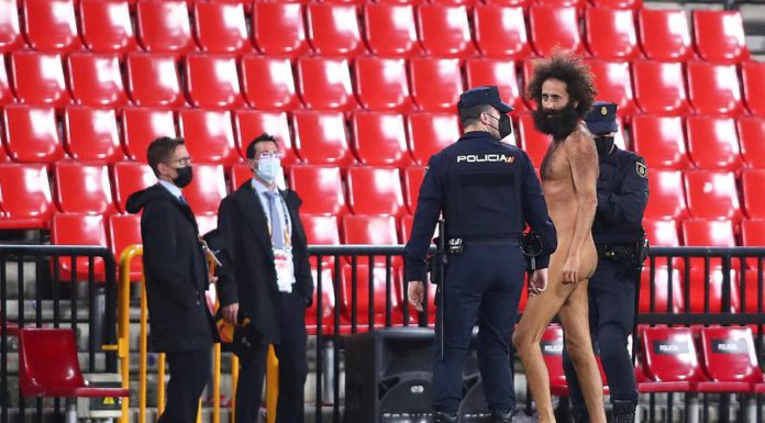 A streaker is being apprehended by the police © Getty Images