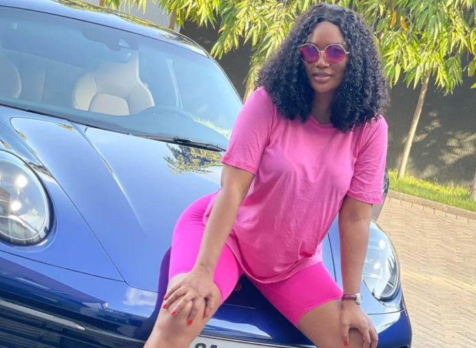 Sandra Ankobiah shows off blue Porsche 911 Carrera