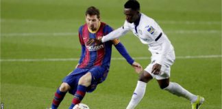 Getafe's Ghanaian midfielder Sabit Abdulai (right) tries to tackle Barcelona's Lionel Messi