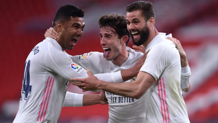 Nacho of Real Madrid celebrates with team mates (L - R) Casemiro and Alvaro Odriozola after scoring their side's first goal during the La Liga Santander match between Athletic Club and Real Madrid Image credit: Getty Images
