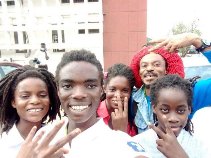 Tyrone Iras Marhguy with his triplet family, together with his father and a relative. Credit: @marhguy_tyrone