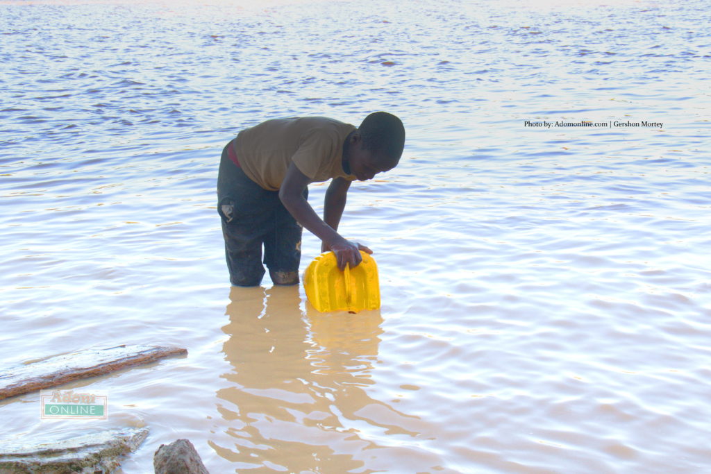 Young lad fetches contaminated water from River Pra